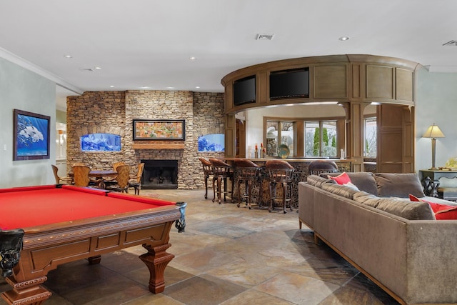 playroom with crown molding, a fireplace, bar area, and pool table