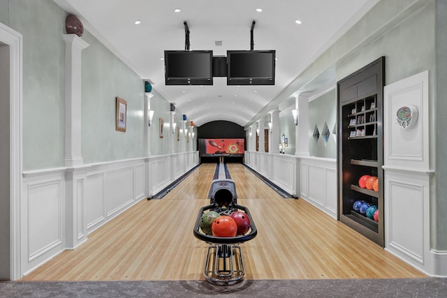 rec room featuring ornate columns, lofted ceiling, and bowling