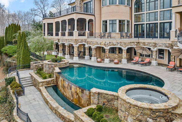 view of swimming pool with a patio area and an in ground hot tub