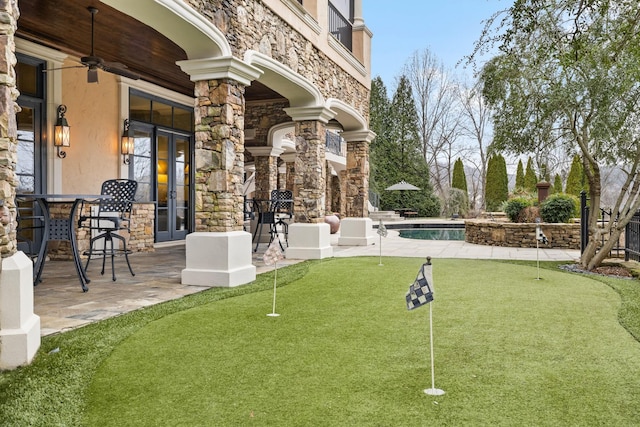 view of property's community featuring a swimming pool and a patio