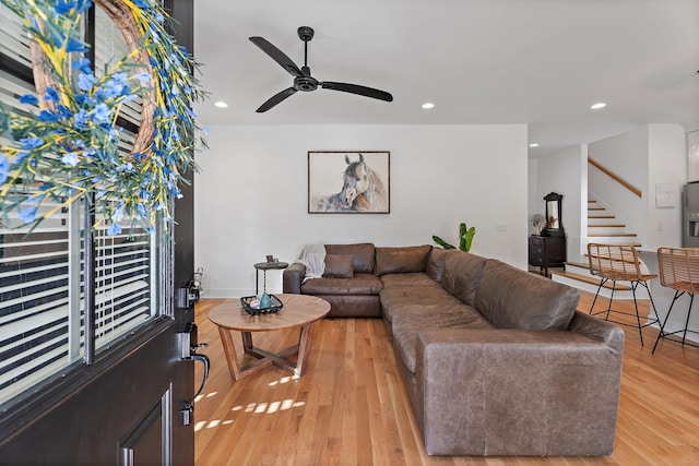 living room featuring light hardwood / wood-style floors and ceiling fan