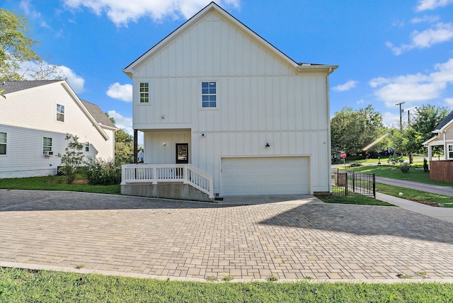 rear view of house with a garage