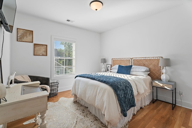 bedroom with hardwood / wood-style flooring