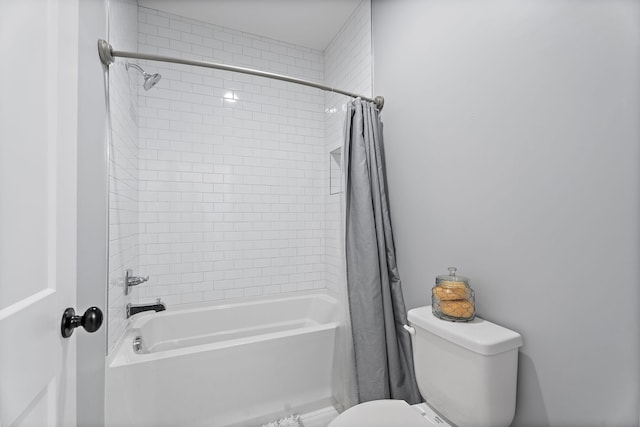 bathroom with shower / bath combo with shower curtain and toilet