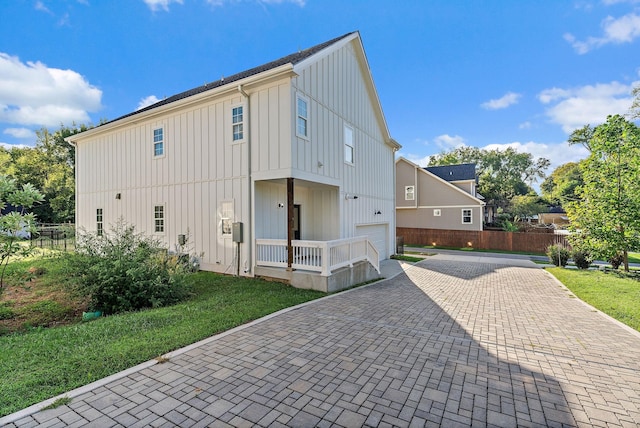 view of property exterior with a garage and a yard