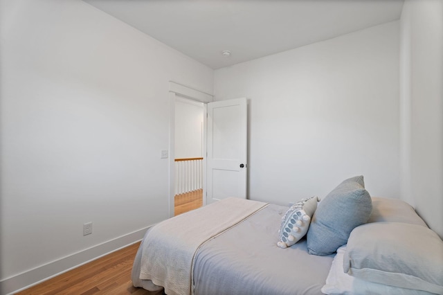 bedroom with wood-type flooring