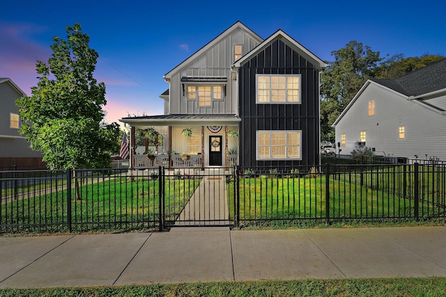 view of front of house with a porch and a yard