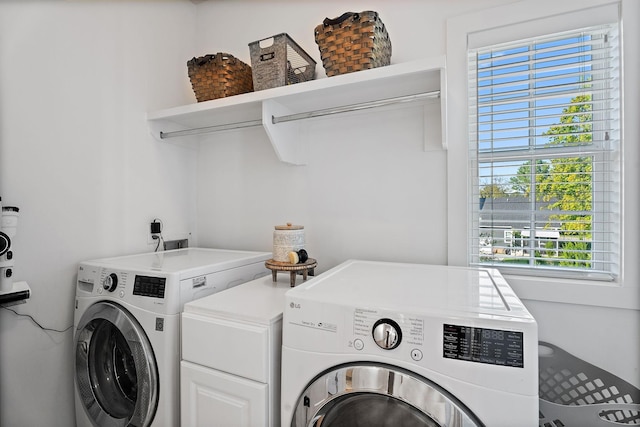 laundry room with washing machine and clothes dryer