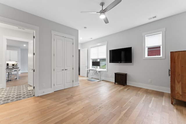 unfurnished living room with ceiling fan and light wood-type flooring