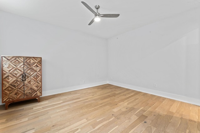 empty room with light hardwood / wood-style floors and ceiling fan