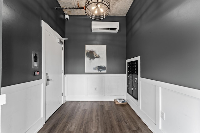 interior space featuring a wall mounted air conditioner, dark hardwood / wood-style floors, and mail boxes