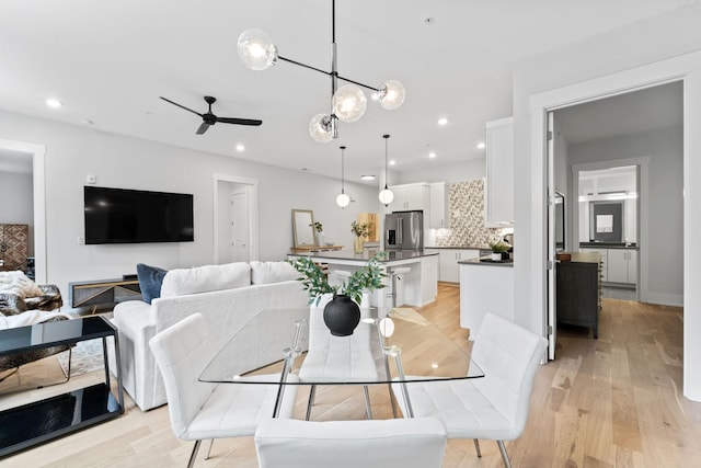 dining space featuring ceiling fan and light hardwood / wood-style flooring