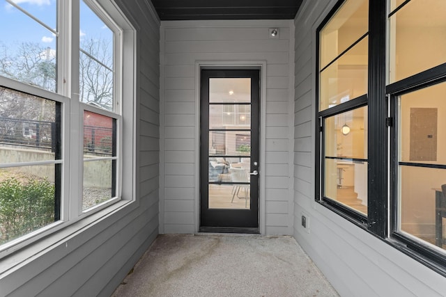 view of exterior entry with a balcony