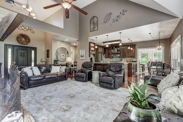 living room featuring ceiling fan with notable chandelier