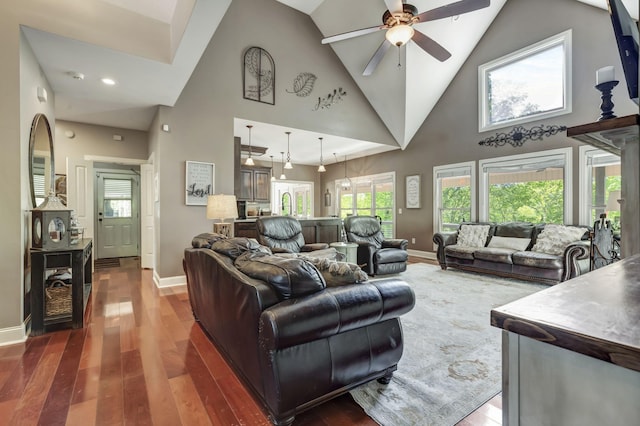 living room featuring high vaulted ceiling, dark hardwood / wood-style floors, and ceiling fan