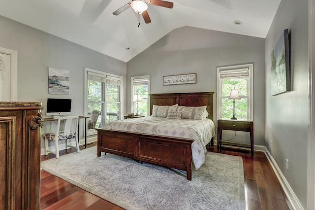 bedroom featuring ceiling fan, dark hardwood / wood-style floors, vaulted ceiling, and multiple windows