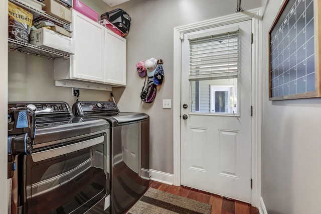 laundry area with cabinets, dark hardwood / wood-style floors, and washer and clothes dryer