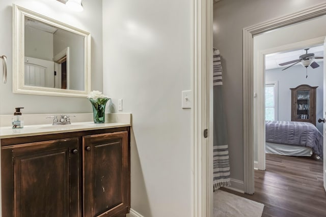 bathroom with ceiling fan, vanity, and wood-type flooring