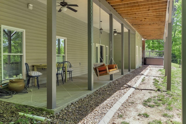 view of patio / terrace featuring ceiling fan and a hot tub