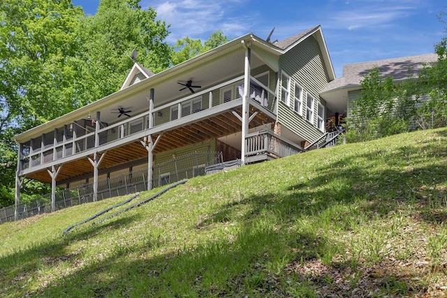 exterior space with ceiling fan, a sunroom, and a lawn