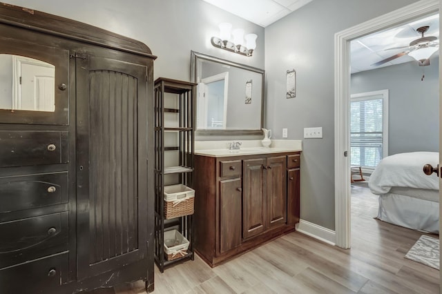 bathroom featuring vanity, hardwood / wood-style floors, and ceiling fan