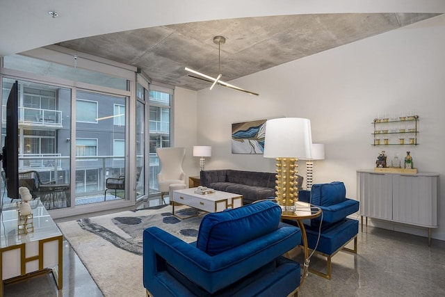 living room with an inviting chandelier and a wall of windows