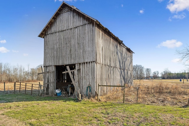 view of outbuilding with a yard and a rural view