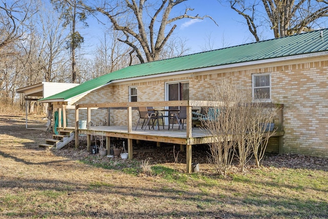 rear view of property featuring a wooden deck