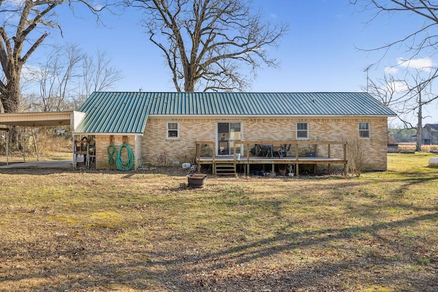 rear view of house with a carport, a wooden deck, and a lawn