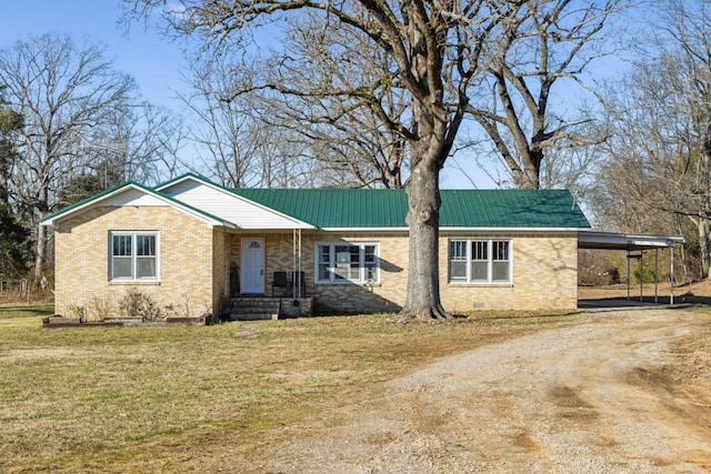 ranch-style house with a carport and a front lawn