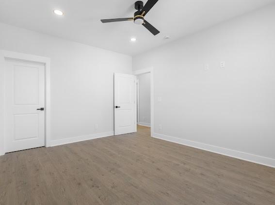 unfurnished bedroom with a ceiling fan, baseboards, wood finished floors, and recessed lighting