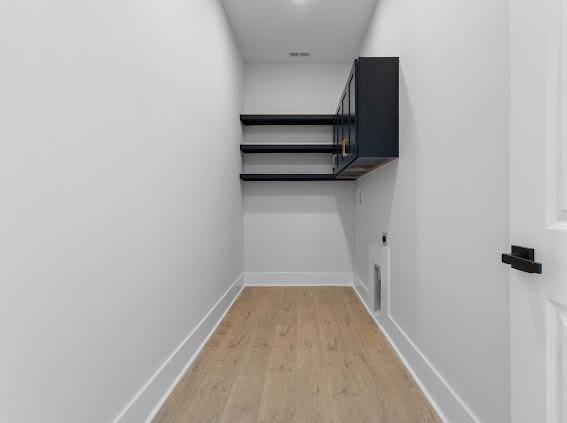 walk in closet with visible vents and wood finished floors