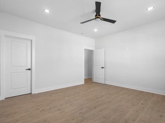 unfurnished room with light wood finished floors, baseboards, a ceiling fan, and recessed lighting