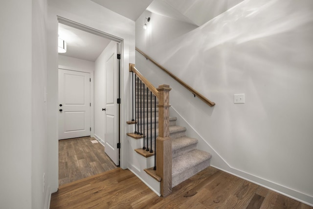 stairway featuring hardwood / wood-style flooring