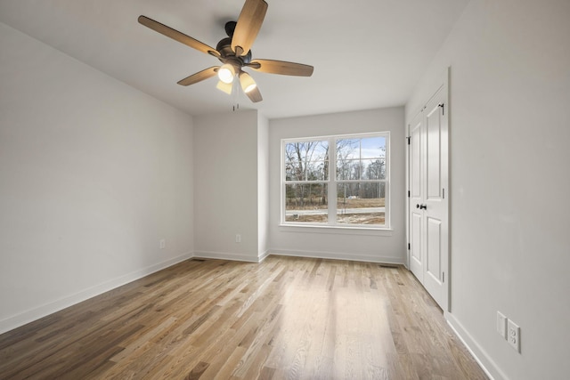 unfurnished room featuring ceiling fan and light wood-type flooring