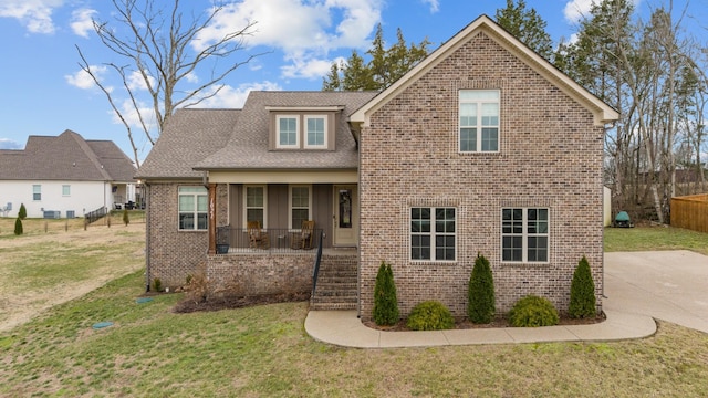 view of front property with covered porch and a front lawn