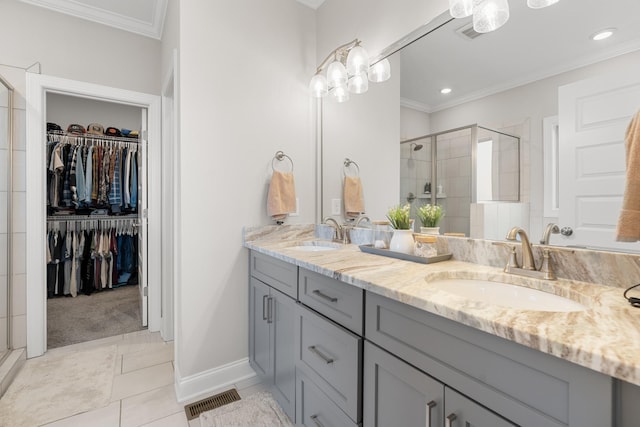 bathroom with crown molding, vanity, and a shower with shower door