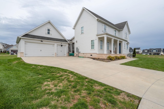 view of side of property featuring a yard, covered porch, and a garage