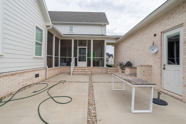 view of patio featuring ceiling fan and a sunroom