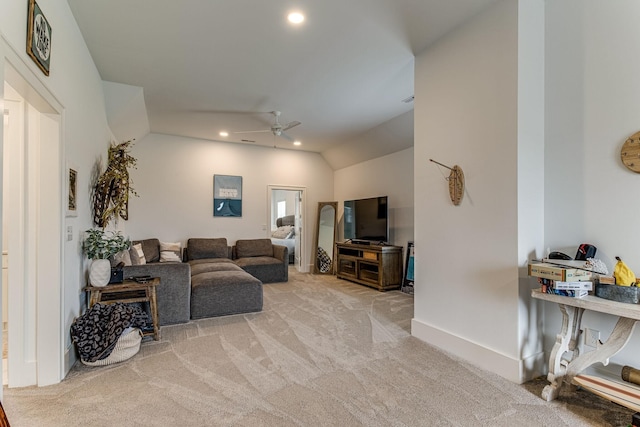 living room featuring vaulted ceiling, light carpet, and ceiling fan