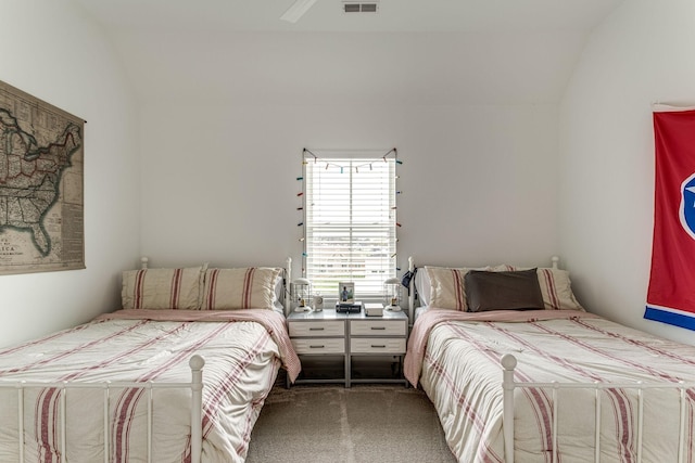 bedroom featuring carpet floors and vaulted ceiling