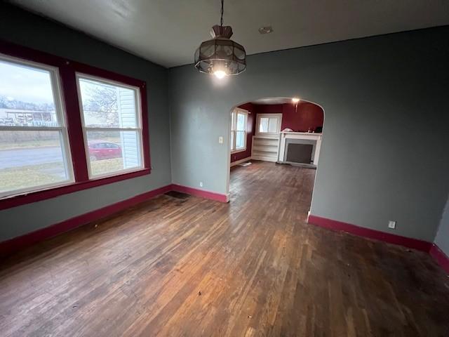 unfurnished dining area featuring dark hardwood / wood-style floors