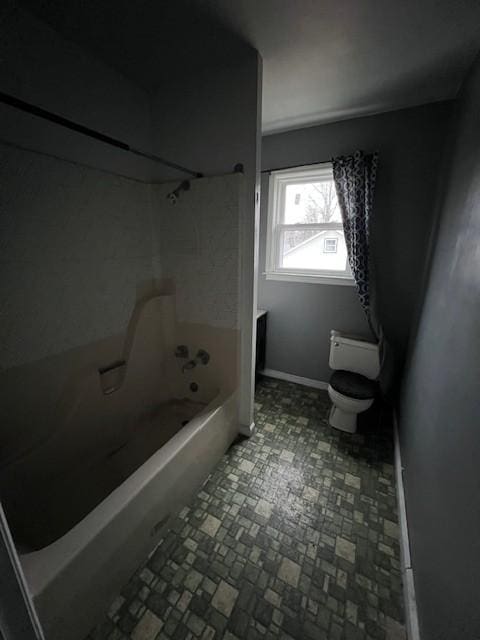 bathroom featuring toilet and bathtub / shower combination