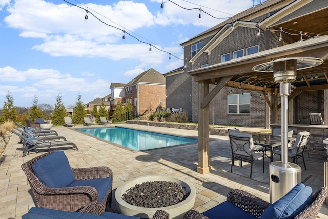 view of pool with a fire pit, a patio, and a gazebo