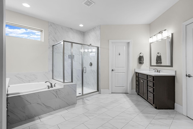 bathroom featuring vanity and shower with separate bathtub