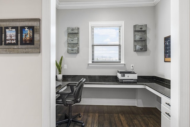 home office with ornamental molding, dark wood-type flooring, and built in desk