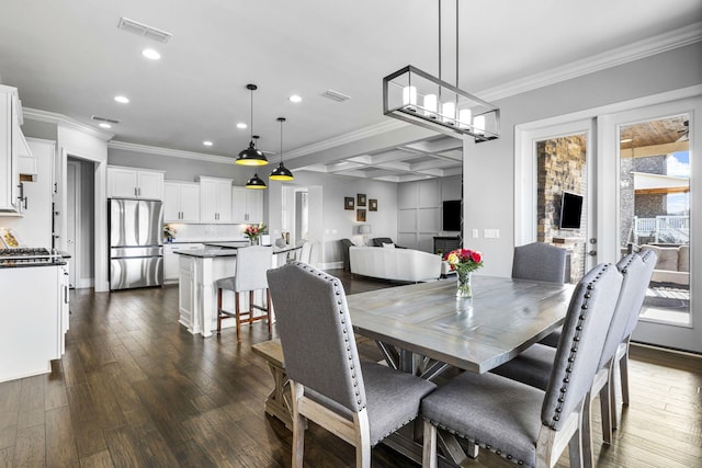 dining area with coffered ceiling, a notable chandelier, crown molding, and dark wood-type flooring