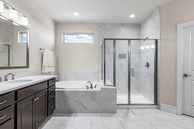 bathroom with vanity and separate shower and tub