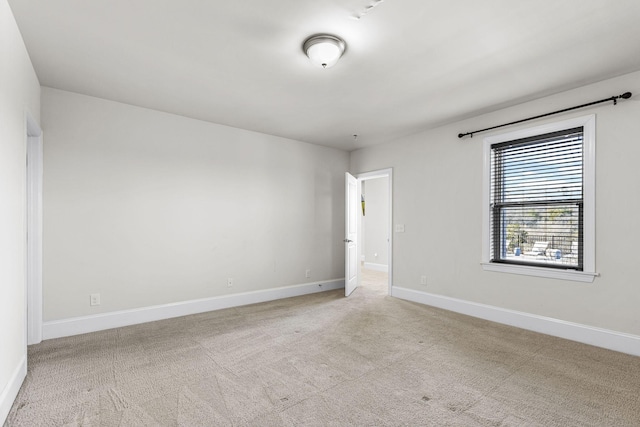 unfurnished room with light carpet