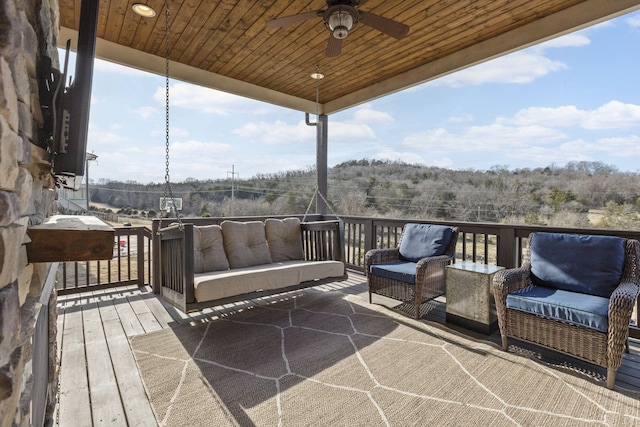 deck with an outdoor hangout area and ceiling fan